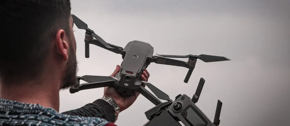 man setting up a drone with camera