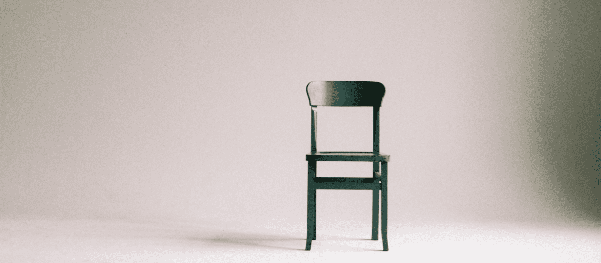 A chair in front of an empty Background representing minimalism